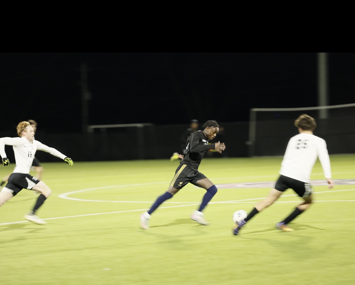 Player dribbling past defenders